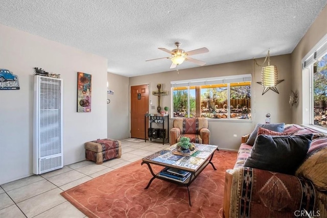 tiled living room with a textured ceiling and ceiling fan