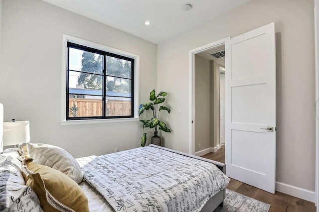 bedroom with dark wood-type flooring