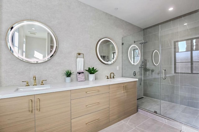 bathroom featuring vanity, tile walls, tile patterned floors, and walk in shower