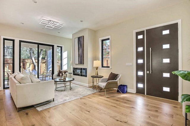 living room featuring plenty of natural light and light wood-type flooring