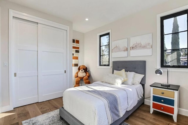 bedroom featuring dark hardwood / wood-style flooring and a closet