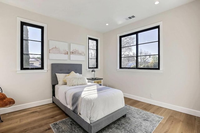 bedroom with hardwood / wood-style floors