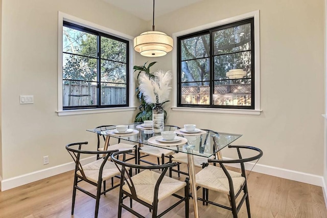 dining space with wood-type flooring