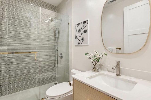 bathroom with vanity, walk in shower, and toilet