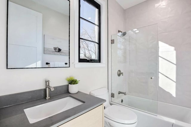 full bathroom featuring enclosed tub / shower combo, vanity, and toilet