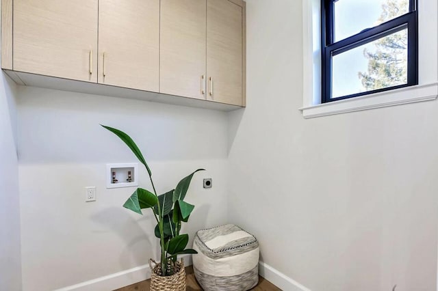 clothes washing area featuring electric dryer hookup, washer hookup, and cabinets