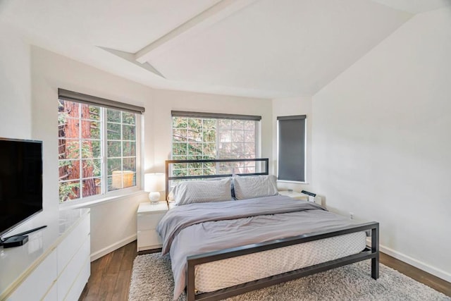 bedroom with dark wood-type flooring and lofted ceiling with beams