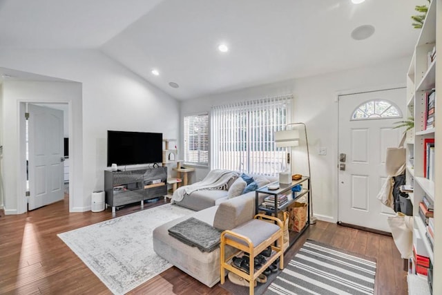 living room featuring vaulted ceiling, plenty of natural light, and dark wood-type flooring