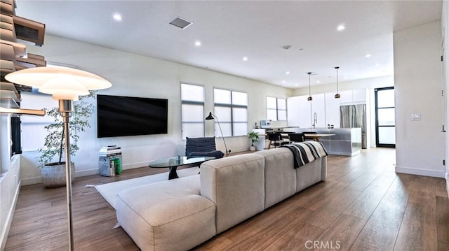 living room featuring sink and hardwood / wood-style flooring