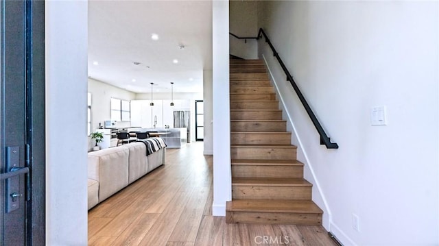 stairs featuring wood-type flooring