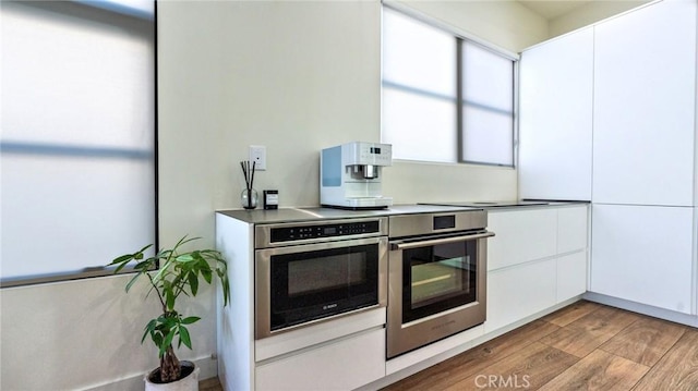 kitchen featuring white cabinetry and light hardwood / wood-style flooring