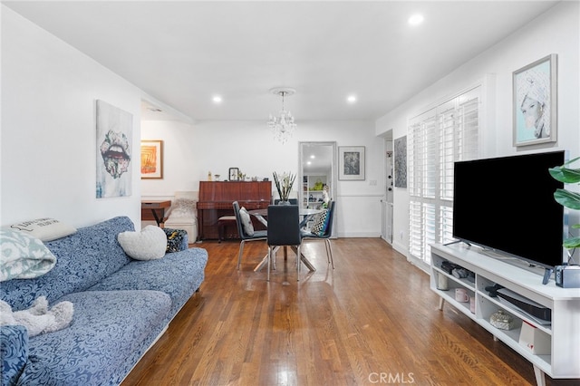 living room with dark hardwood / wood-style floors and a chandelier