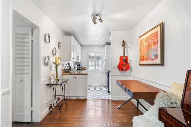 kitchen featuring white cabinetry and dark wood-type flooring