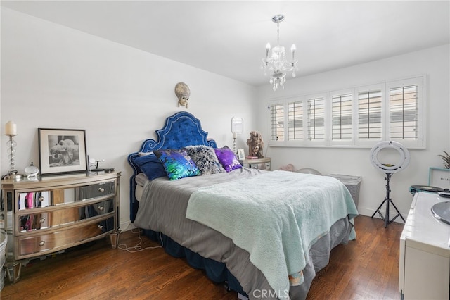 bedroom featuring dark wood-type flooring and a notable chandelier