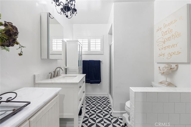 bathroom with vanity, toilet, and walk in shower