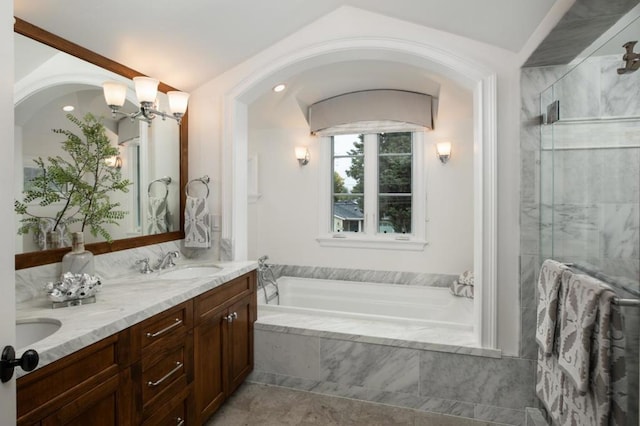 bathroom with an inviting chandelier, vanity, shower with separate bathtub, and tile patterned flooring