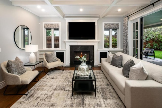 living room featuring wood-type flooring, coffered ceiling, and a healthy amount of sunlight