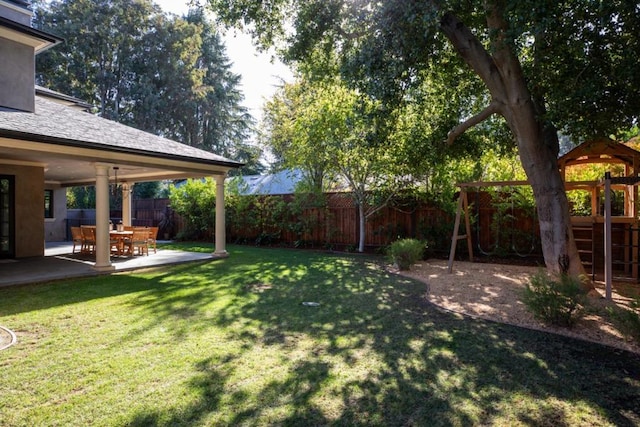 view of yard with a playground and a patio