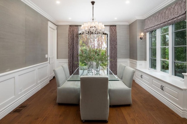 dining space featuring crown molding, dark hardwood / wood-style floors, and a chandelier