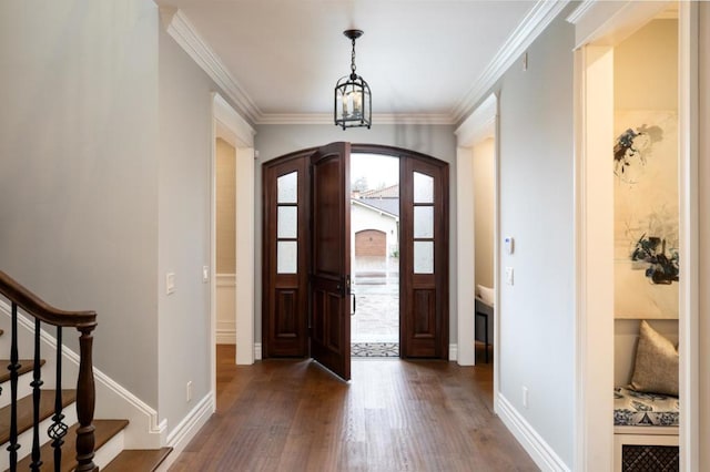 entrance foyer featuring ornamental molding and dark hardwood / wood-style floors