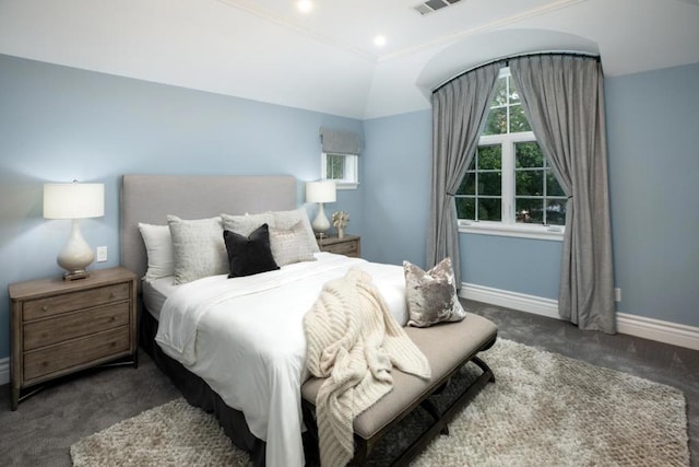 bedroom featuring dark colored carpet and lofted ceiling