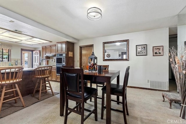 dining area with light colored carpet