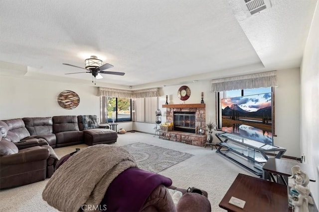 carpeted living room with ceiling fan and a textured ceiling