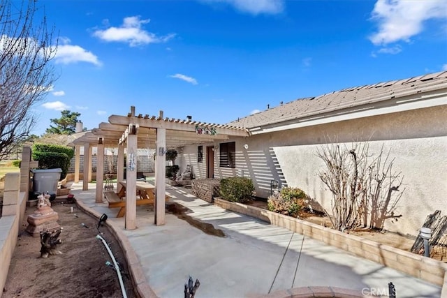 rear view of property with a pergola and a patio area