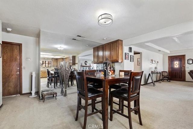 carpeted dining room featuring radiator heating unit