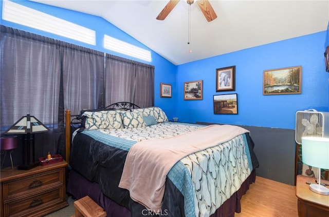 bedroom featuring ceiling fan, lofted ceiling, and wood finished floors