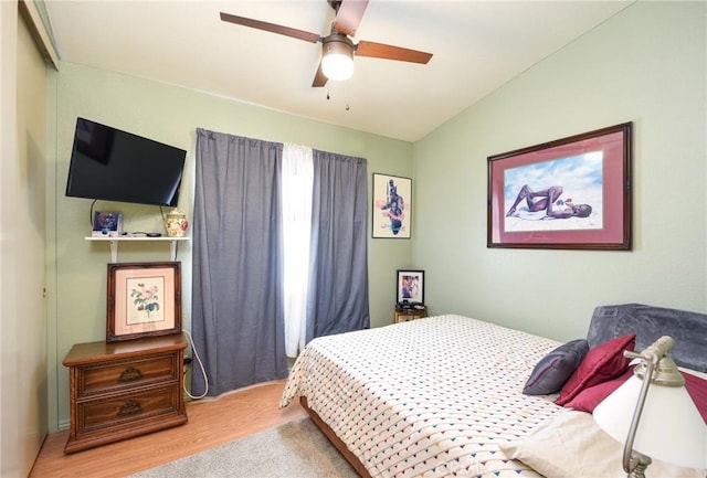 bedroom with wood finished floors, a ceiling fan, and vaulted ceiling