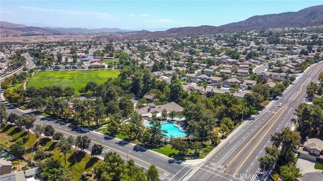 13057 Fescue Ct, Corona, CA 92883 - view of property location featuring a mountain backdrop, a pool, a major roadway, and nearby suburban area