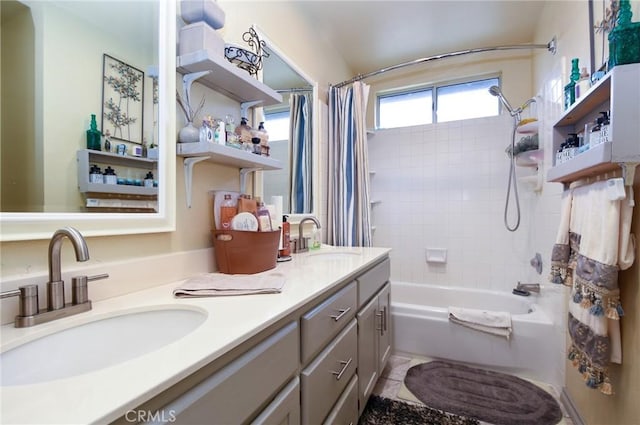 full bathroom with double vanity, shower / bathtub combination with curtain, and a sink