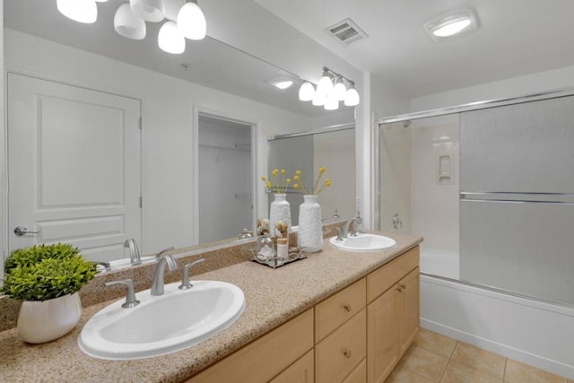 bathroom with vanity, combined bath / shower with glass door, and tile patterned flooring