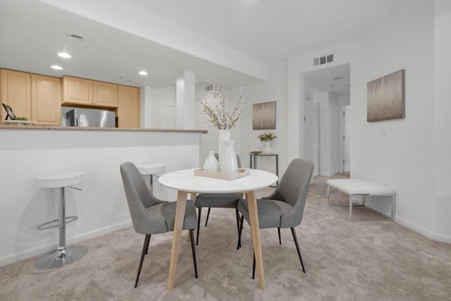 dining space with light colored carpet