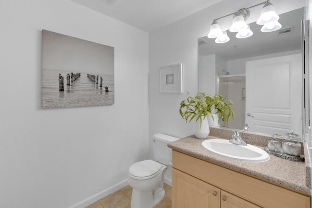 bathroom with an enclosed shower, vanity, tile patterned flooring, and toilet