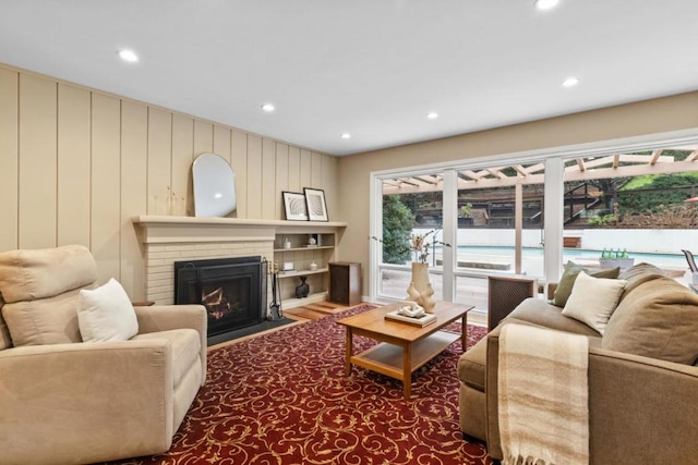 living room with hardwood / wood-style flooring and a fireplace