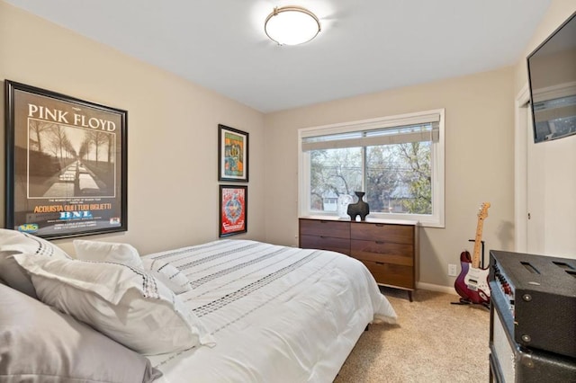 bedroom featuring light carpet