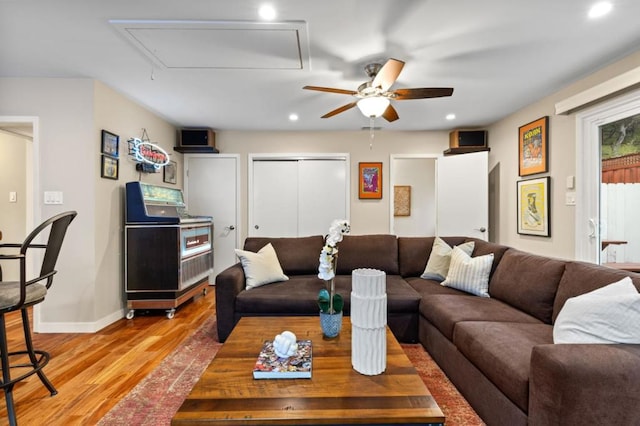 living room with light hardwood / wood-style floors and ceiling fan