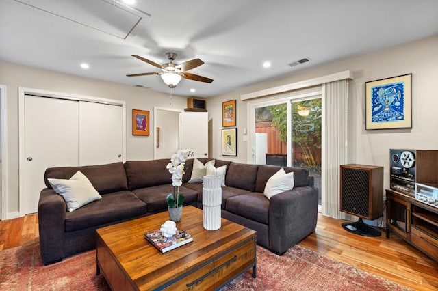 living room featuring hardwood / wood-style floors and ceiling fan