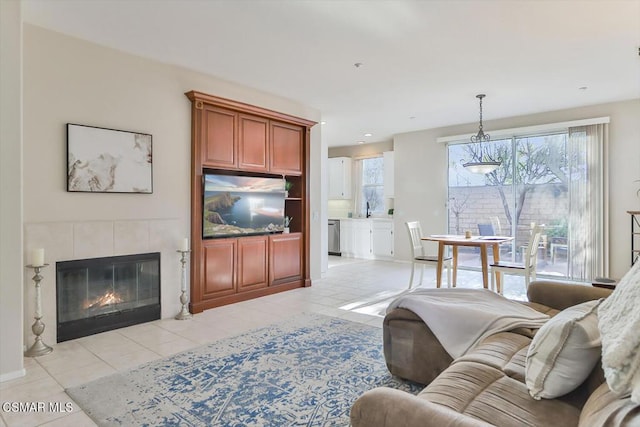 tiled living room with a tile fireplace and sink