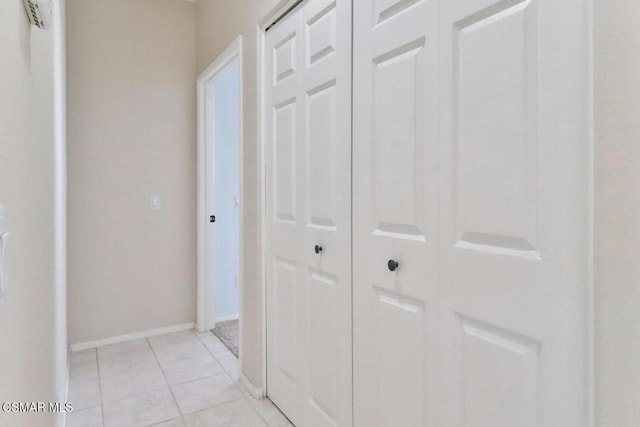 hall featuring light tile patterned floors