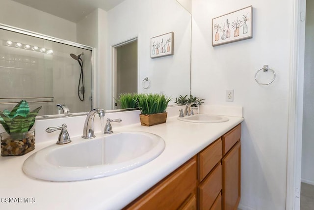 bathroom with vanity and a shower with door