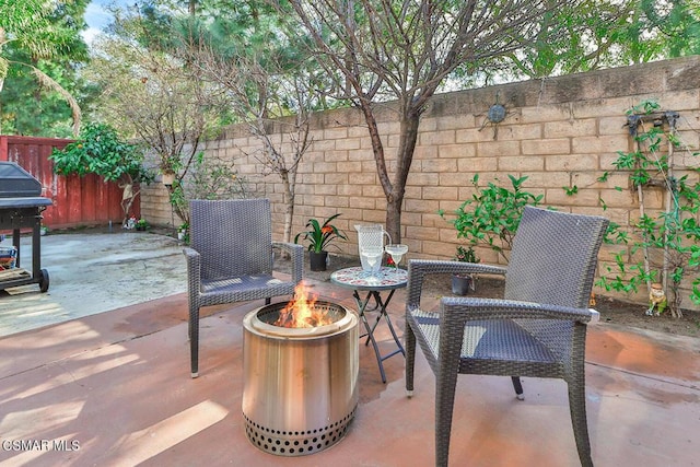 view of patio featuring grilling area and a fire pit