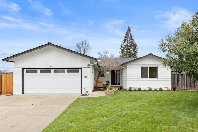 ranch-style house featuring a garage and a front lawn