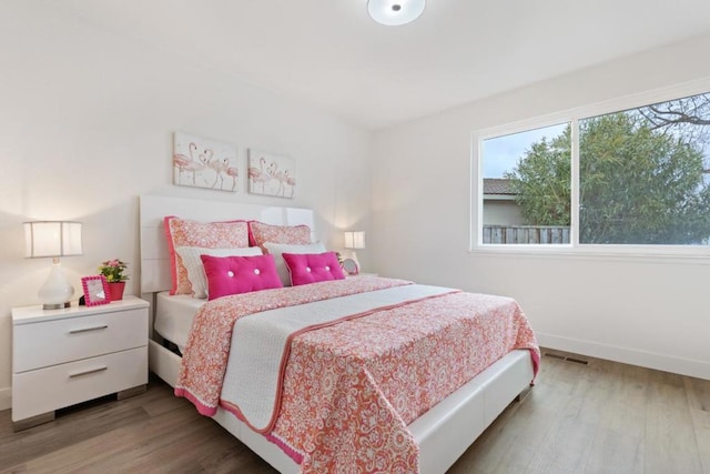 bedroom with wood-type flooring