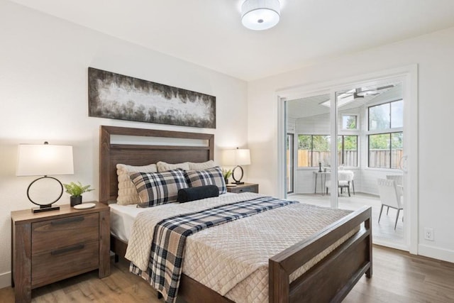 bedroom featuring access to exterior and wood-type flooring