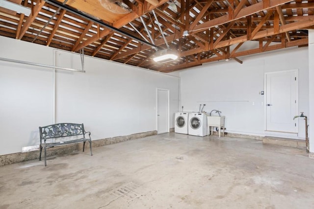 garage featuring sink and washer and clothes dryer