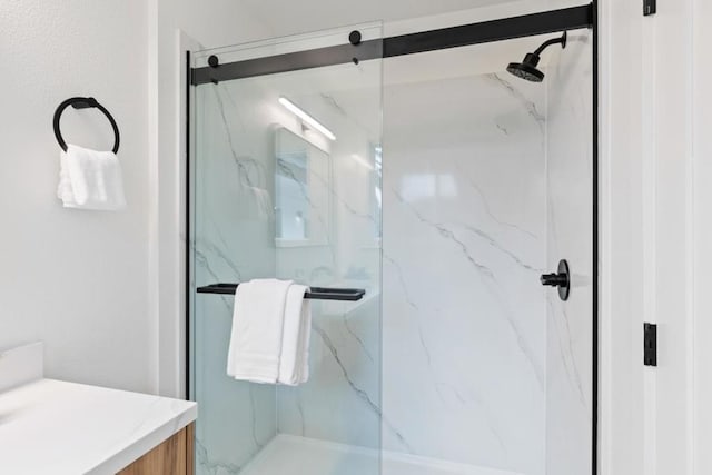 bathroom with an enclosed shower and vanity