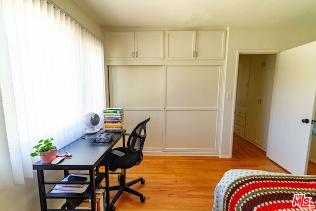 office area with light hardwood / wood-style floors